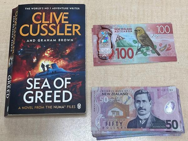 One of the novels and cash recovered.