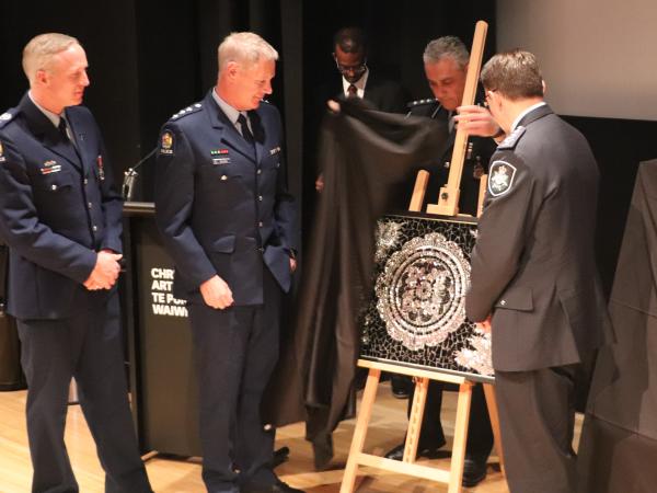 Two mosaics were gifted to Police. Senior Sergeant Aaron Brady and Inspector Bryan Buck accepted one on behalf of AOS and STG. 
