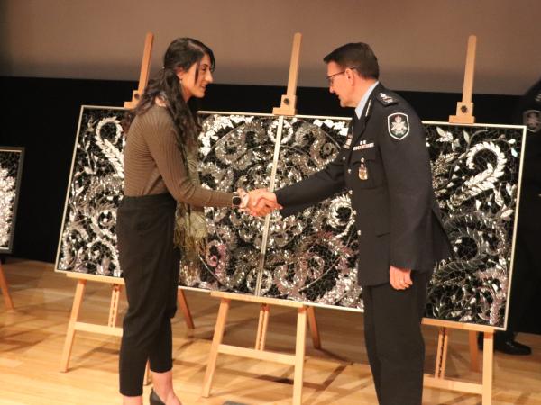 ?? accepted the artworks on behalf of the Muslim community from Australian Federal Police Commissioner Reece Kershaw. 