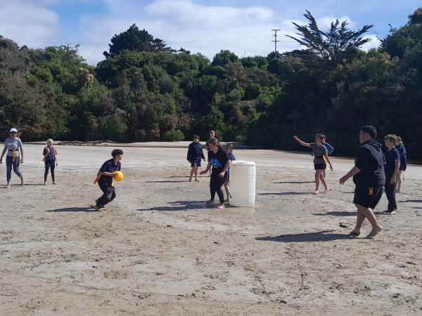 Action shot of kids playing sport on the beach.