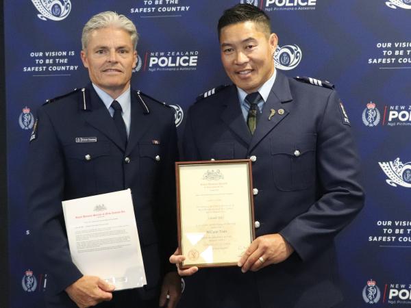 Assistant Commissioner Richard Chambers presents the Royal Humane Society Award to Sergeant Willie Tran.