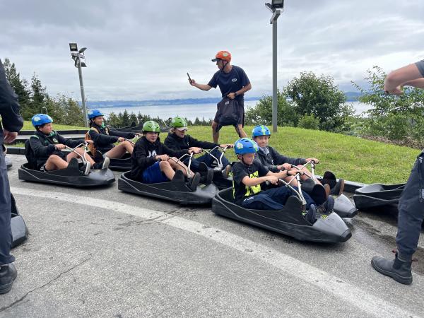 Senior Constable Che Lind snaps a photo as the children head off on the luge.