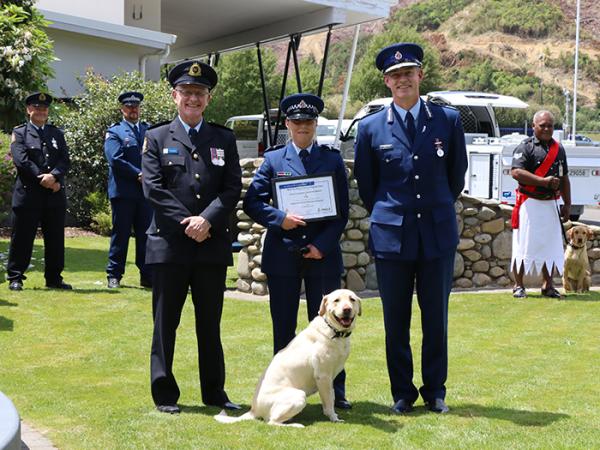 Senior Constable Zoe Eginton and Villa receive their graduation certificate from Commissioner Andrew Coster.
