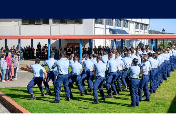 Alan and his family watch on as recruits perform a haka to honour his commitment to policing. 