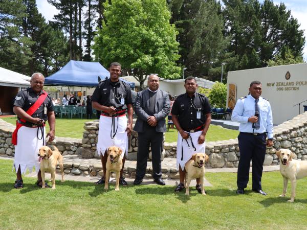 The newly graduated Fijian dog teams with Second Secretary Fiji High Commission Josua Tewere.