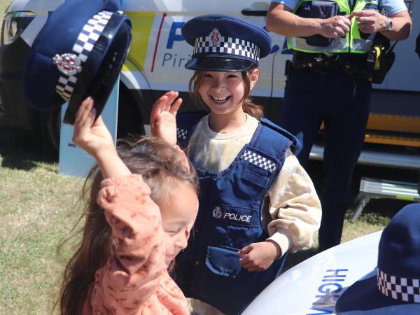 Young kids dressing up in Police uniforms.