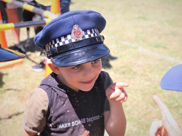 A child dressed up in police uniform. 
