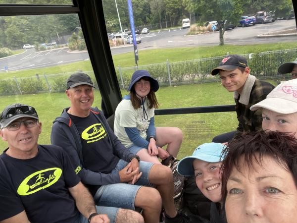 Senior Constables Mark Johnson and Bruce Ward and Constable Hazel Mitchell with some of the children in the Rotorua gondola.