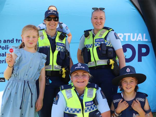Senior Sergeant Melanie Robertson and Constables Katie Haldane and Shawny Hokai with some happy visitors to the recruitment tent