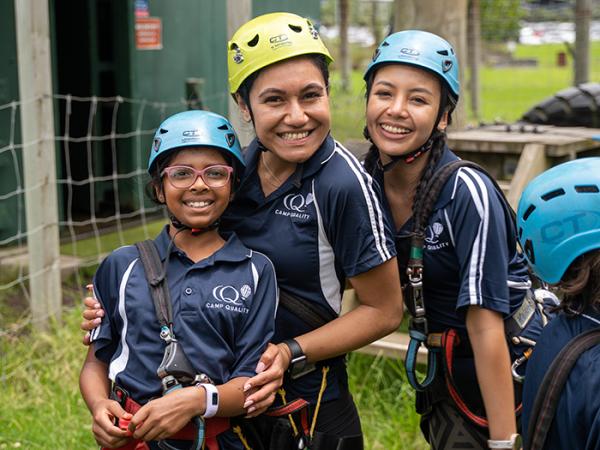 Detective Constable Kiyara Pouhila-Simpson and two of the attendees,all wearing safety hard hats. 