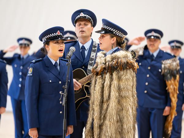 Constables Anastasia Lee, Nathan Durham and Jade Vercoe lead the National Anthem.