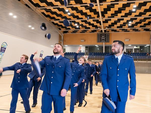 The newly graduated constables throwing their hats in the air.  