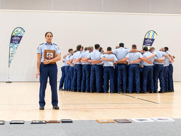 Members of the wing lay down photos of loved ones who had passed before performing the Police haka.