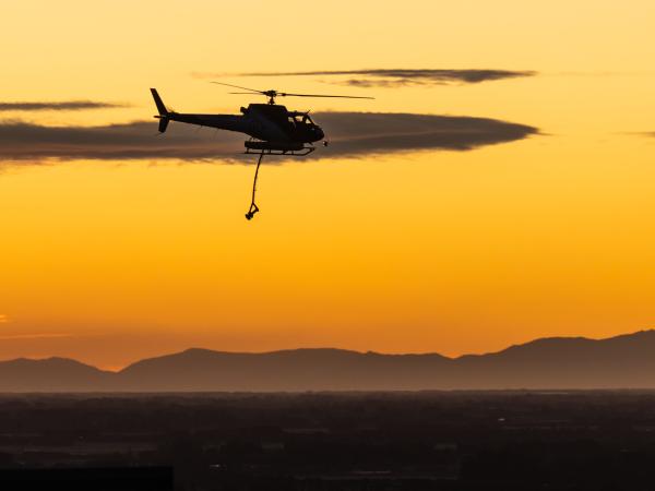 The last water drop of the day - helicopters return to ground while fire crews work through the night.