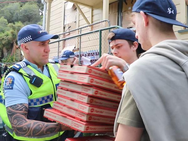 Sergeant Steve Jones delivering pizza to students