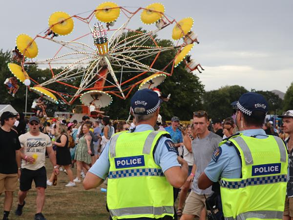View of the backs of two police officers during the Electric Avenue one day festival. 