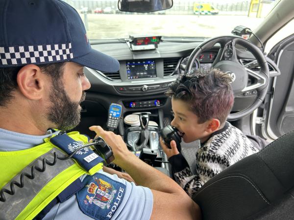 A potential future recruit checks out the car radio.