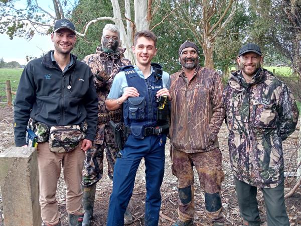Fish and Game Ranger Cohen Stewart (far left) with Invercargill Constable Dylan Burtenshaw and some happy hunters.