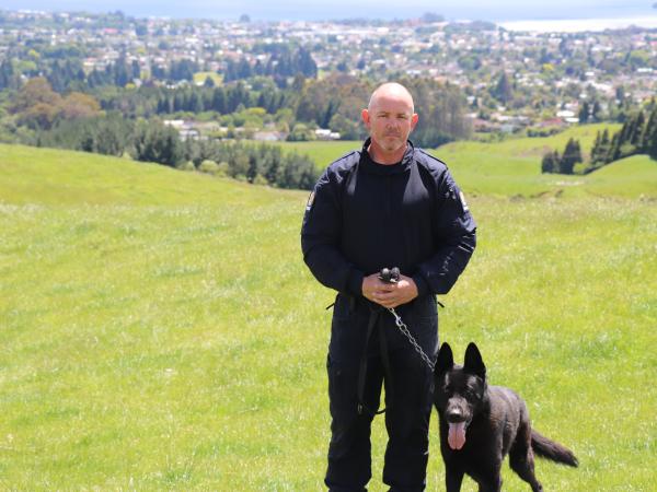 Senior Constable Billy Hill  and Indo on a hill.