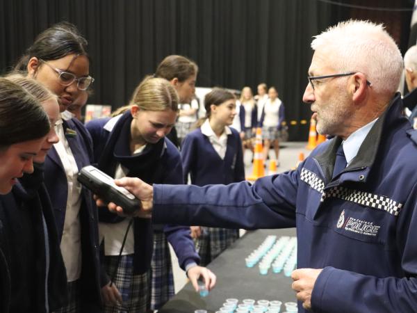 Senior Constable Mark Johnson gives students a chance to experience being breathalysed.