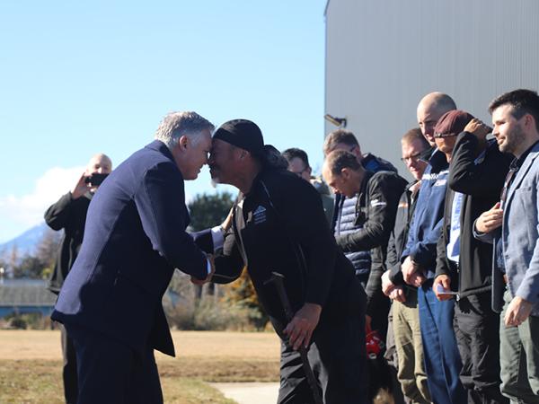 Minister Mitchell and Aiden Gilbert greet each other with hongi.