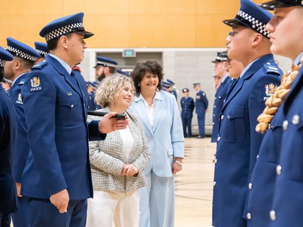 Patron Dr Diana Sarfati and Associate Police Minister Casey Costello share a moment with the graduates on inspection.