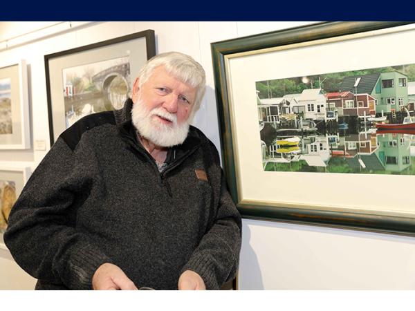 Retired police photographer Bruce Hutton with one of his photographs.