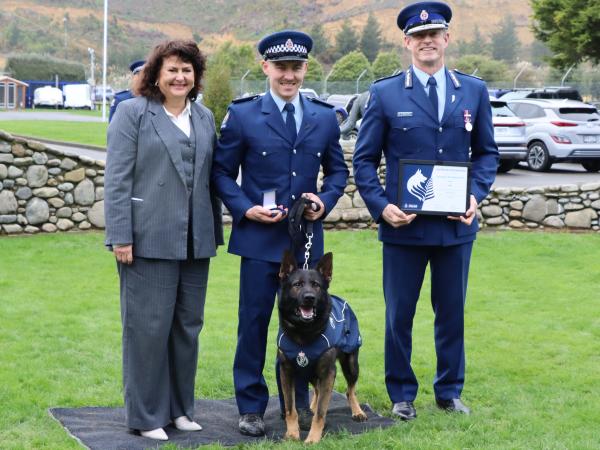 Constable Jarom Brouwer and Tahi with Associate Minister Casey Costello and Commissioner Andrew Coster.