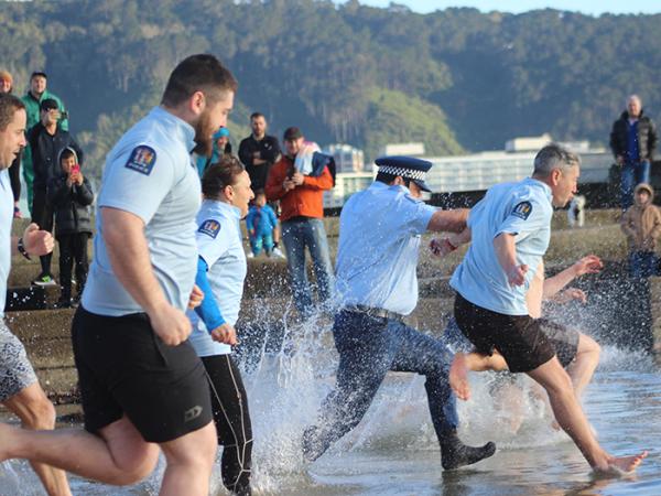 Officers running into the sea for the Polar Plunge.