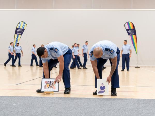Members of Wing 376 place portraits of loved ones centre stage before performing their haka. 