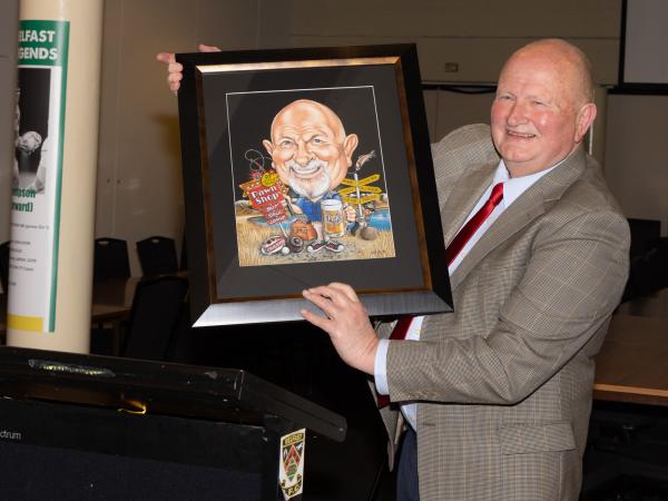 Detective Sergeant Don Fisher with his likeness; a gift from colleagues on his retirement.