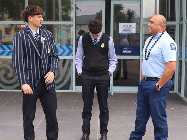 Constable Tonu Tauamiti with two Tautua students outside New Brighton Police Station.
