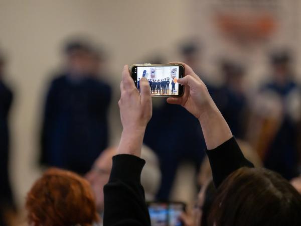 Close up of a mobile phone being used to film the graduation.