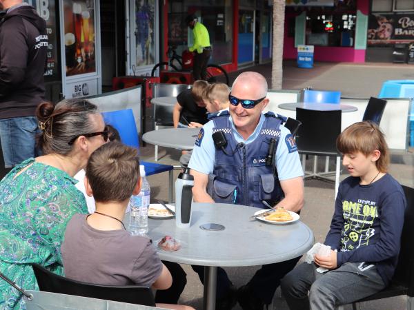 Senior Constable Dave Power chatting with a family in Marewa.