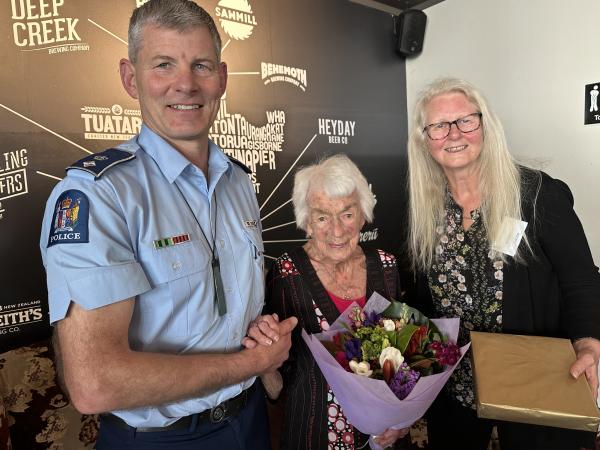 District Commander Superintendent Corrie Parnell and Wellington Retired Police Members Club President Sharron Taylor help Marie 