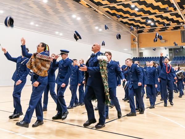 Wing 379 throw their hats in the air as parade is dismissed.