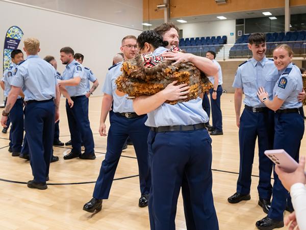 Newly graduated constables from Wing 379 hugging after their graduation.