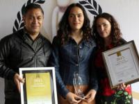 Te Roera and Caroline with Awa - and the Wellington Pride Awards she won in 2015 for her YouTube videos.