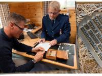 Senior Constable Aaron Smith and US Ambassador Scott Brown study the artefacts.