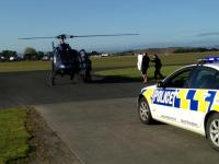 Police dog 'Gus' being carried to the helicopter that took him to Auckland
