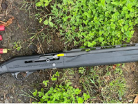 A cut down and loaded semi-automatic shotgun was located, along with other ammunition.