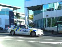 Police car driving past Police station