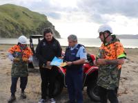 Senior Sergeant Maui Aben and Terence Maru from Rongomaiwahine Iwi Trust discuss the new quad bike brochure with two of the iwi'