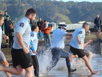 Officers running into the sea for the Polar Plunge.